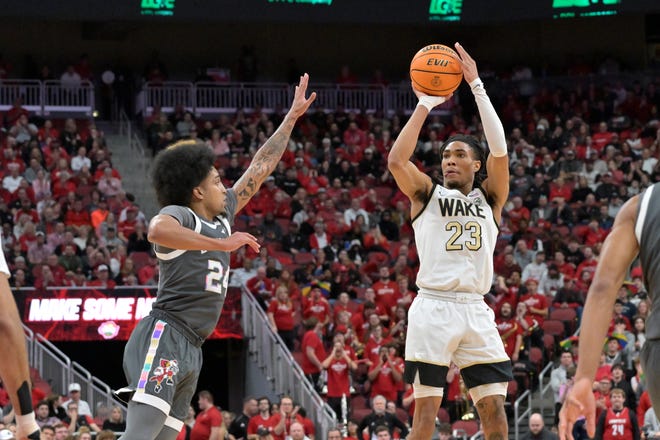 Jan 28, 2025; Louisville, Kentucky, USA; Wake Forest Demon Deacons guard Hunter Sallis (23) shoots against Louisville Cardinals guard Chucky Hepburn (24) during the first half at KFC Yum! Center. Mandatory Credit: Jamie Rhodes-Imagn Images