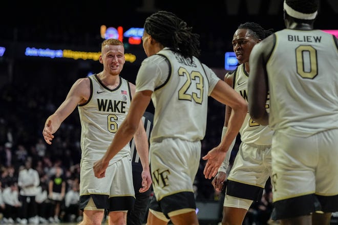 Feb 12, 2025; Winston-Salem, North Carolina, USA; Wake Forest Demon Deacons guard Cameron Hildreth (6) high fives guard Hunter Sallis (23) during a game against the Florida State Seminoles at Lawrence Joel Veterans Memorial Coliseum. Jim Dedmon-Imagn Images